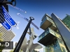 Manchester civil justice centre law courts wide angle shot with street signs in foreground bright sunny day blue sky