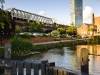 Castlefield canal Manchester. Bright sunny day blue sky beetham hilton hotel canal lock railway viaduct bridge fluffy clouds