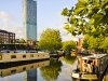 Castlefield canal area Manchester. Bright sunny day with canal and barge in the foreground  Beetham Hilton hotel in background